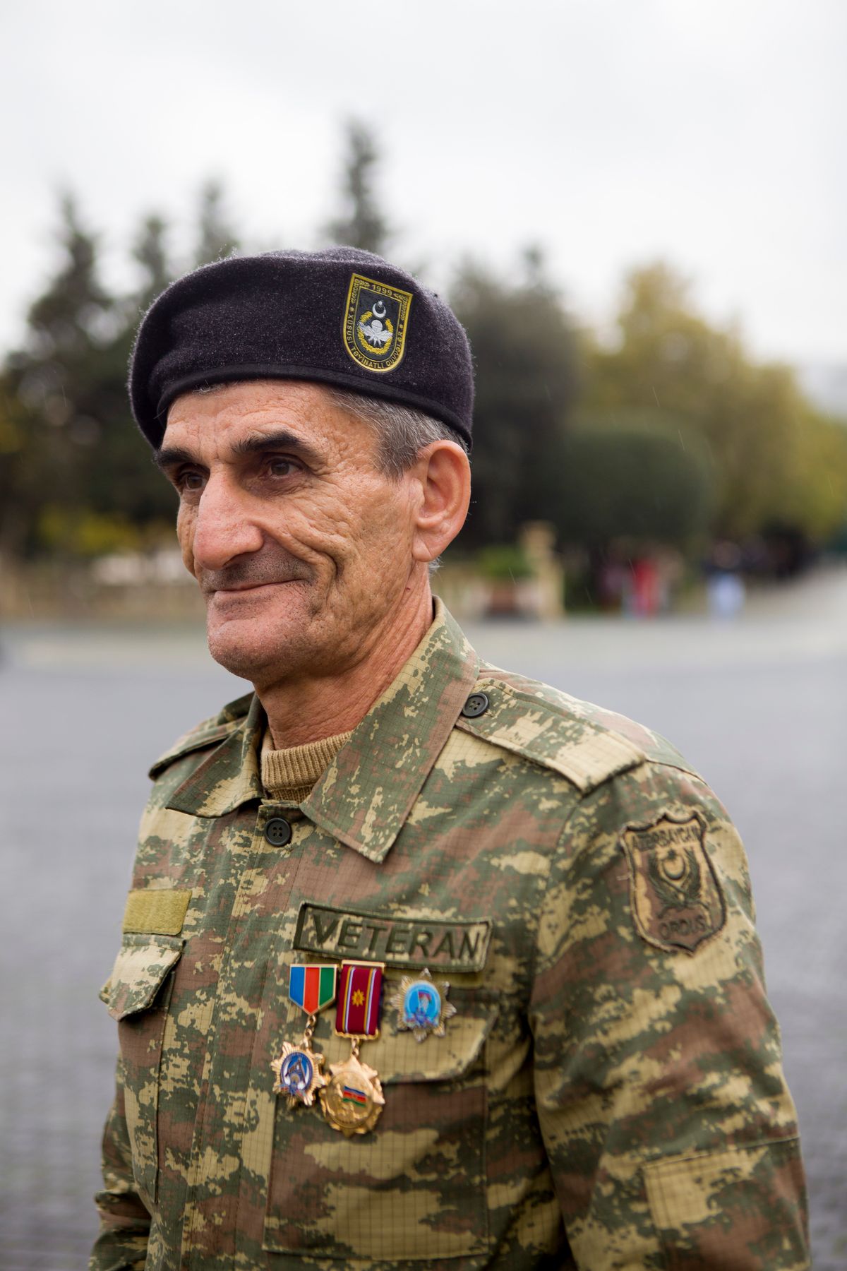A service member in uniform with service medals at a community event